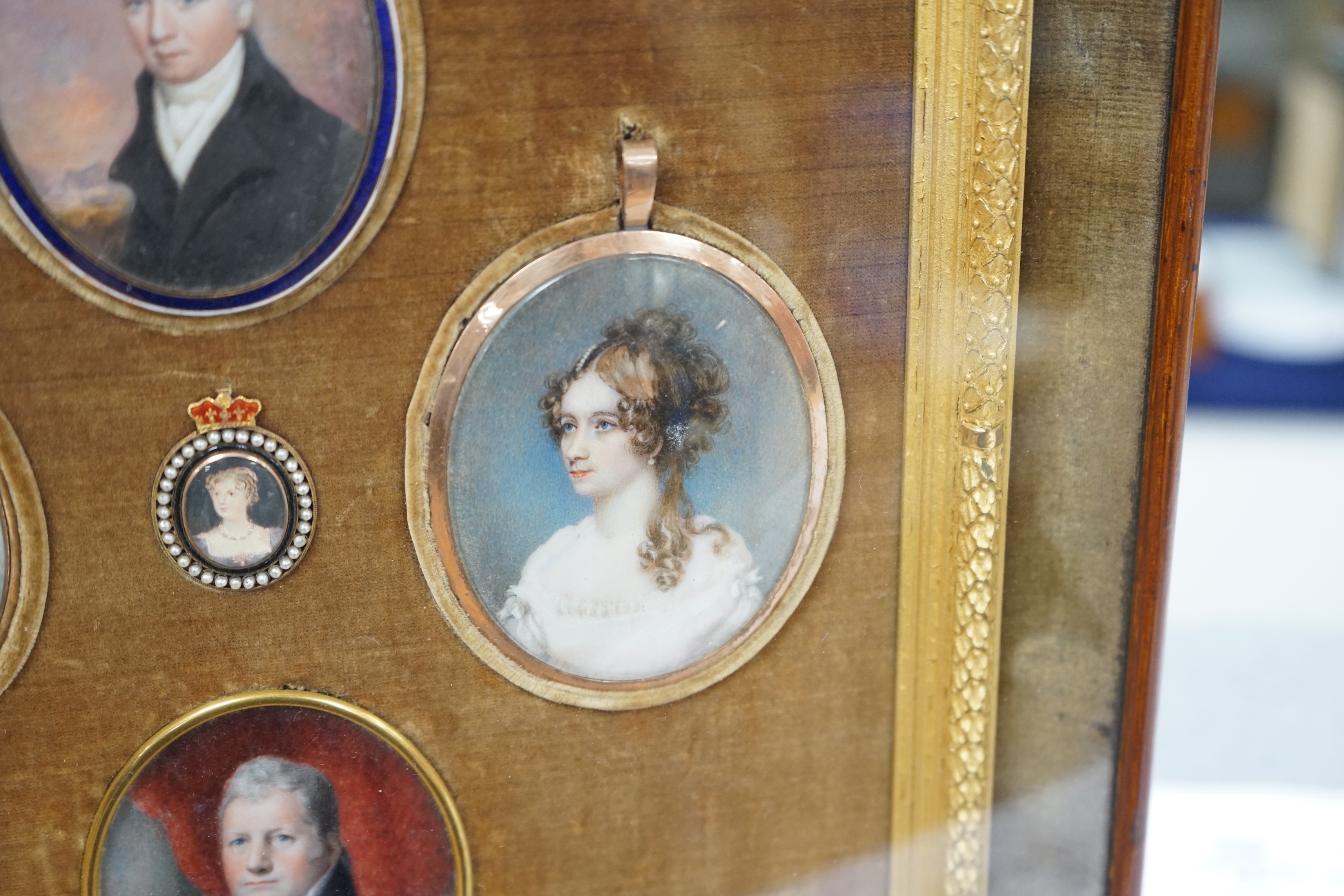 A group of five 19th century portrait miniatures on ivory, framed as one, in a decorative gilt and velvet mount rosewood frame. Overall 36 x 32cm
